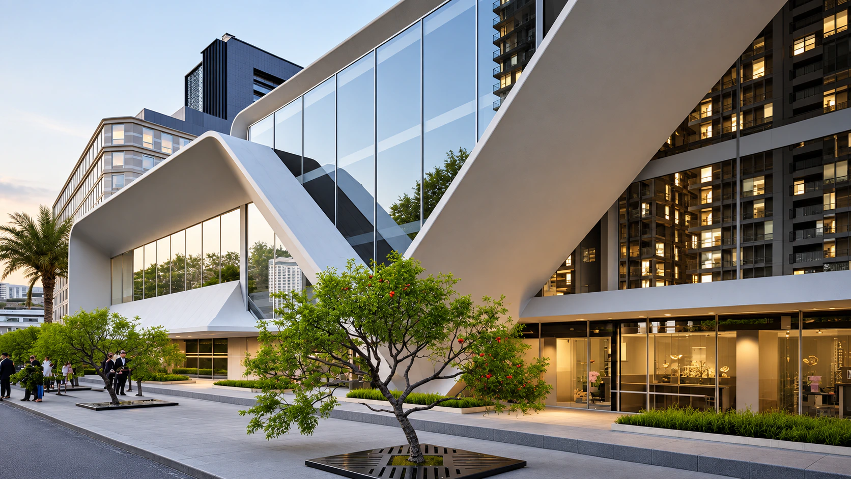 White V-shaped building facade with glazing and a tree in the foreground.